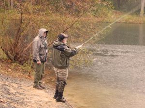 Instructor showing student 2-handed fly rod technique