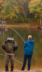 Instructor working with student showing how to cast a 2-handed fly rod