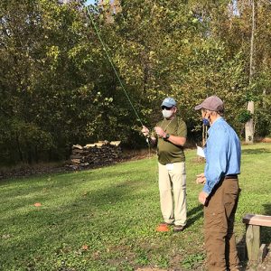 Instructor working with a student on how to cast with a fly rod